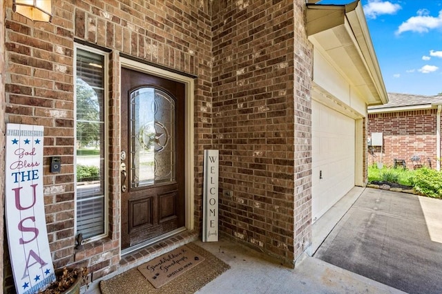 4472 Gerona St, League City, TX 77573 - property entrance with brick siding, a garage, and concrete driveway