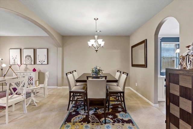 4472 Gerona St, League City, TX 77573 - dining space with arched walkways, light carpet, and a chandelier