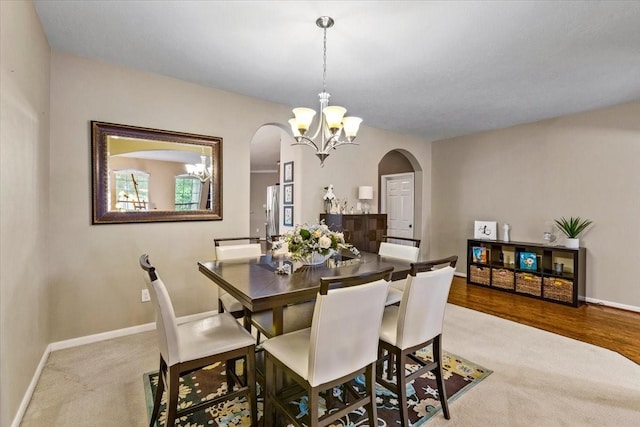 4472 Gerona St, League City, TX 77573 - carpeted dining space with arched walkways and a chandelier