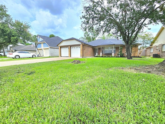 14519 Cypress Valley Dr, Cypress, TX 77429 - view of front of home with concrete driveway, a front lawn, a garage, and brick siding