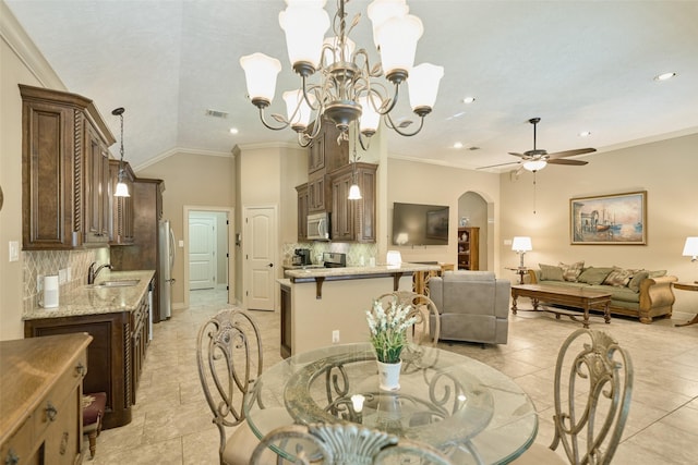 11917 Walden Rd, Montgomery, TX 77356 - dining space with arched walkways, a ceiling fan, recessed lighting, a chandelier, and vaulted ceiling