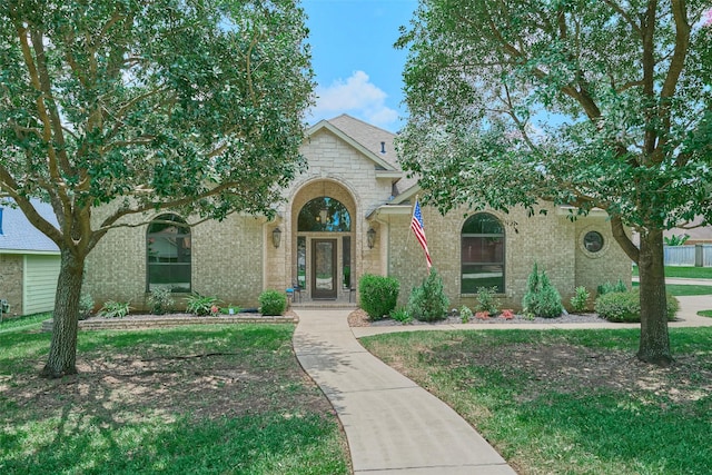 11917 Walden Rd, Montgomery, TX 77356 - view of front of house featuring brick siding, stone siding, and a front lawn