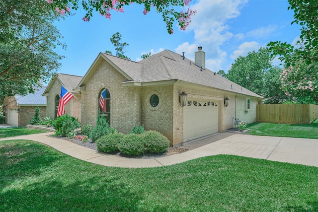 11917 Walden Rd, Montgomery, TX 77356 - view of front of home with an attached garage, a chimney, concrete driveway, and a shingled roof