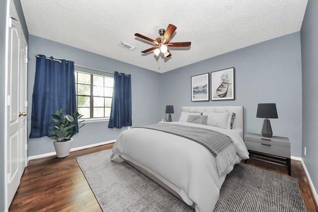 3107 Dulaney Rd, Houston, TX 77084 - bedroom featuring wood finished floors, a textured ceiling, and a ceiling fan