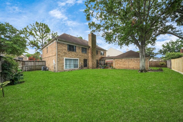 3107 Dulaney Rd, Houston, TX 77084 - rear view of property featuring a chimney, a fenced backyard, and brick siding