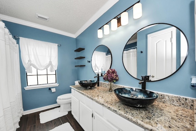 3107 Dulaney Rd, Houston, TX 77084 - full bath with double vanity, a textured ceiling, ornamental molding, and wood finished floors