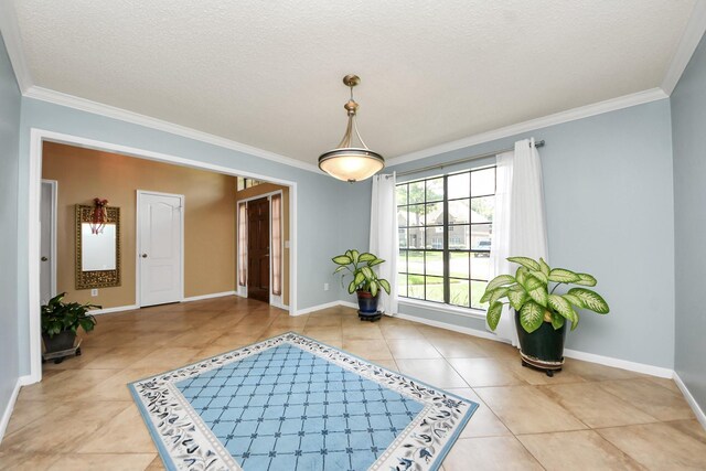 3107 Dulaney Rd, Houston, TX 77084 - entryway with ornamental molding, light tile patterned flooring, and a textured ceiling