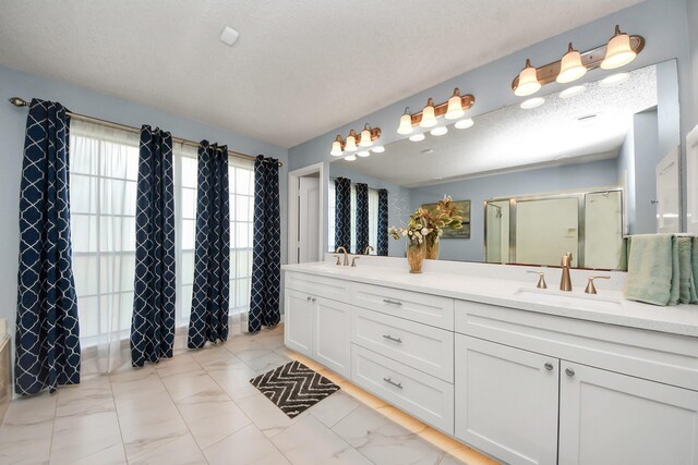 3107 Dulaney Rd, Houston, TX 77084 - full bathroom with double vanity, an enclosed shower, and marble look tile flooring