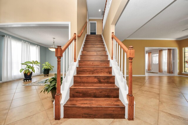 3107 Dulaney Rd, Houston, TX 77084 - stairway featuring healthy amount of natural light, ornamental molding, and tile patterned flooring