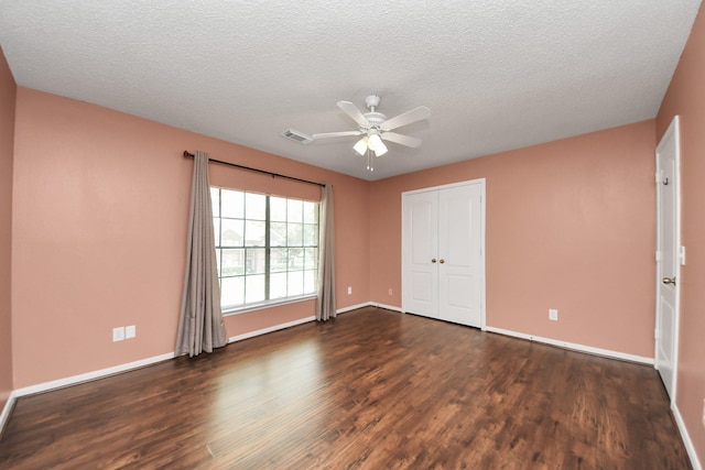 3107 Dulaney Rd, Houston, TX 77084 - unfurnished bedroom featuring dark wood finished floors, a closet, a ceiling fan, and a textured ceiling