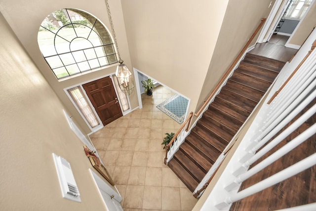 3107 Dulaney Rd, Houston, TX 77084 - foyer entrance featuring a towering ceiling, light tile patterned floors, and stairs