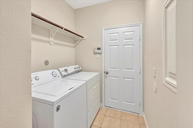 4473 Gran Canary Dr, League City, TX 77573 - laundry room featuring washing machine and dryer and light tile patterned floors
