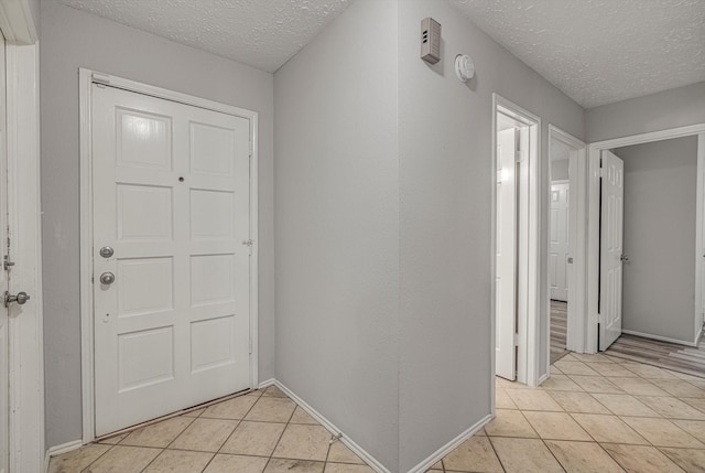 22307 Silver Morning Cir, Katy, TX 77450 - foyer entrance with light tile patterned floors and a textured ceiling