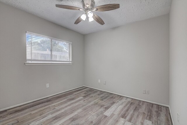 22307 Silver Morning Cir, Katy, TX 77450 - unfurnished room featuring wood finished floors, a textured ceiling, and a ceiling fan