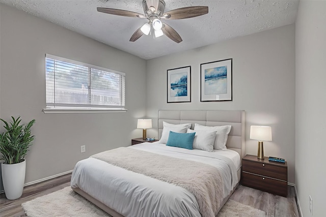 22307 Silver Morning Cir, Katy, TX 77450 - bedroom with wood finished floors, a textured ceiling, and a ceiling fan