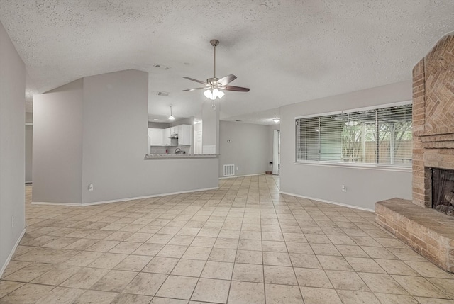 22307 Silver Morning Cir, Katy, TX 77450 - unfurnished living room with a brick fireplace, lofted ceiling, a ceiling fan, a textured ceiling, and light tile patterned floors