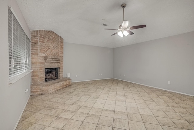 22307 Silver Morning Cir, Katy, TX 77450 - unfurnished living room featuring ceiling fan, a fireplace, a textured ceiling, and lofted ceiling