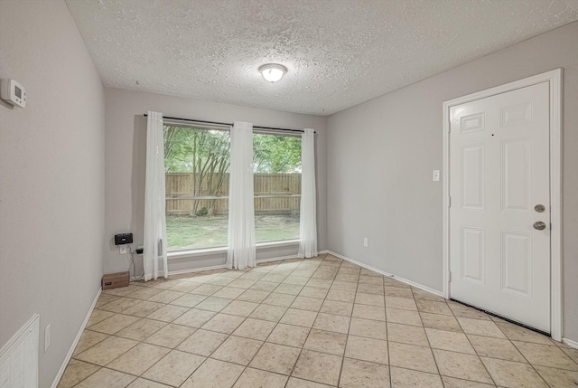 22307 Silver Morning Cir, Katy, TX 77450 - empty room with a textured ceiling and light tile patterned floors