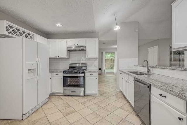 22307 Silver Morning Cir, Katy, TX 77450 - kitchen featuring stainless steel appliances, under cabinet range hood, decorative backsplash, white cabinetry, and a textured ceiling