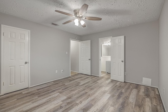22307 Silver Morning Cir, Katy, TX 77450 - unfurnished bedroom with wood finished floors, a textured ceiling, connected bathroom, and ceiling fan