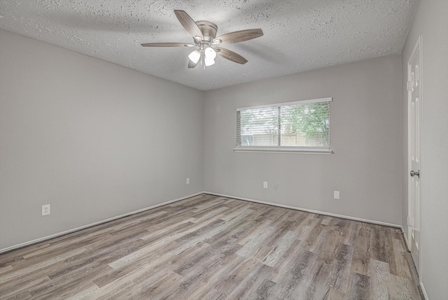 22307 Silver Morning Cir, Katy, TX 77450 - empty room with wood finished floors, ceiling fan, and a textured ceiling