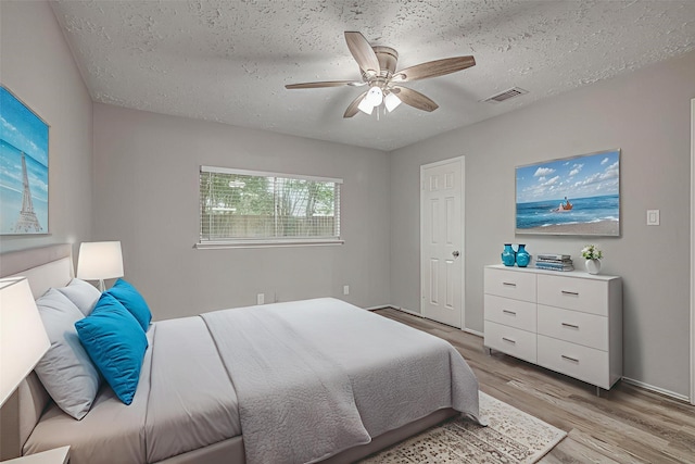 22307 Silver Morning Cir, Katy, TX 77450 - bedroom featuring light wood-type flooring, a textured ceiling, and a ceiling fan