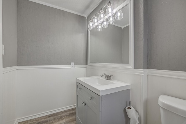 22307 Silver Morning Cir, Katy, TX 77450 - half bathroom with vanity, wood finished floors, wainscoting, crown molding, and a decorative wall