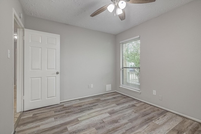 22307 Silver Morning Cir, Katy, TX 77450 - empty room with ceiling fan, wood finished floors, and a textured ceiling
