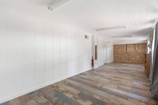 14590 N Tram Rd, Splendora, TX 77372 - spare room featuring brick wall, wood finished floors, and wooden ceiling