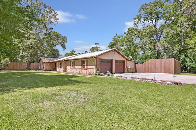 14590 N Tram Rd, Splendora, TX 77372 - single story home featuring a garage, driveway, stone siding, and a metal roof