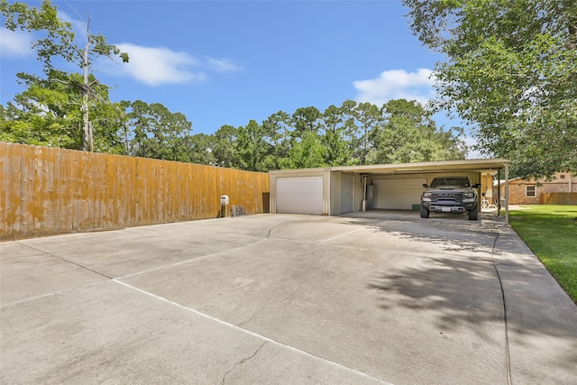 14590 N Tram Rd, Splendora, TX 77372 - view of property exterior with an attached garage, concrete driveway, and an outdoor structure
