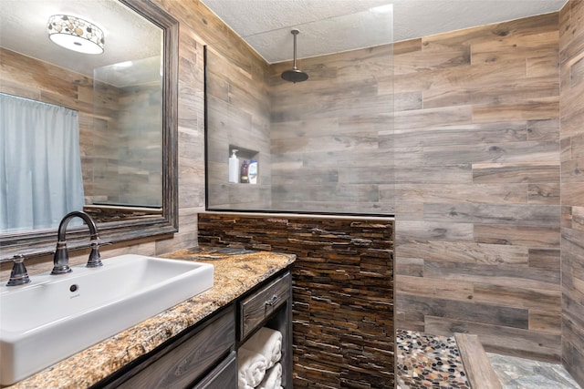 14590 N Tram Rd, Splendora, TX 77372 - bathroom with vanity, a walk in shower, and a textured ceiling