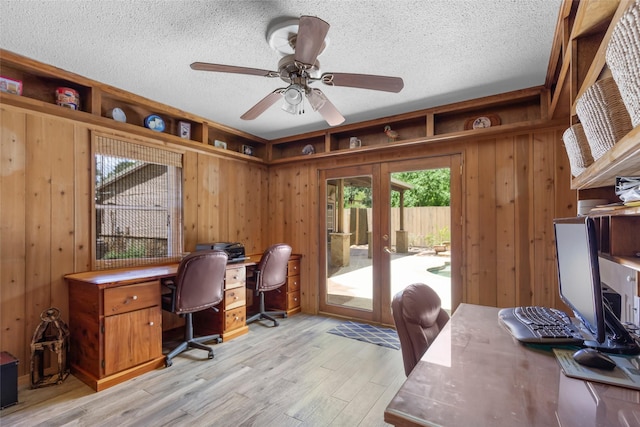 14590 N Tram Rd, Splendora, TX 77372 - office area with french doors, a textured ceiling, wooden walls, light wood finished floors, and a ceiling fan