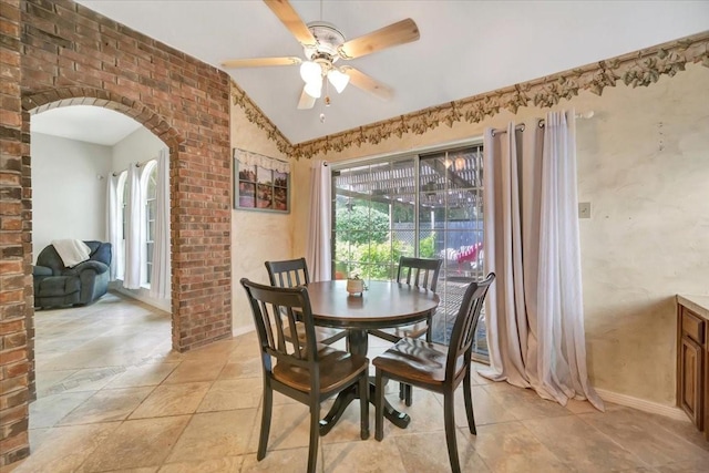 14523 Hillside Hickory Ct, Houston, TX 77062 - dining room with lofted ceiling, a ceiling fan, arched walkways, and light stone finish flooring