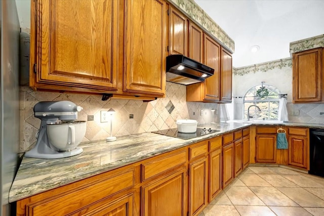 14523 Hillside Hickory Ct, Houston, TX 77062 - kitchen featuring black appliances, under cabinet range hood, decorative backsplash, and brown cabinets