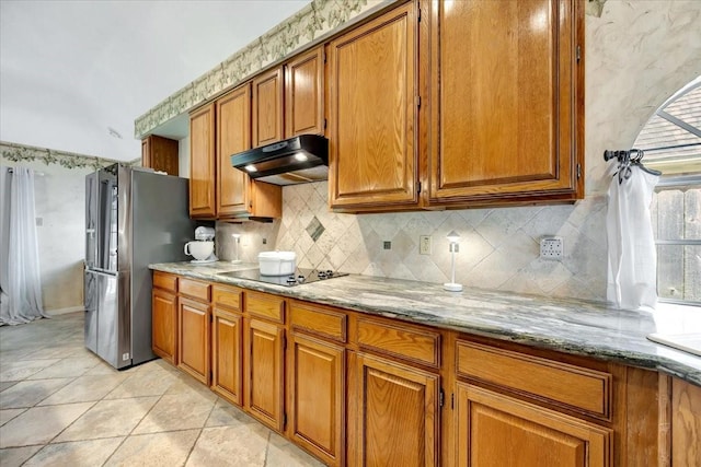 14523 Hillside Hickory Ct, Houston, TX 77062 - kitchen with under cabinet range hood, freestanding refrigerator, black electric cooktop, and brown cabinetry