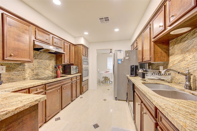 14143 Lost Meadow Ln, Houston, TX 77079 - kitchen with under cabinet range hood, black electric stovetop, stainless steel double oven, backsplash, and recessed lighting