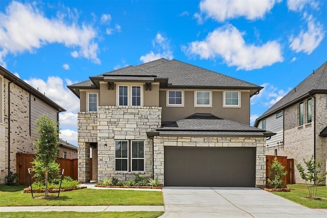 24239 Oakland Mist Ln, Katy, TX 77494 - view of front facade featuring stone siding, stucco siding, driveway, an attached garage, and a shingled roof