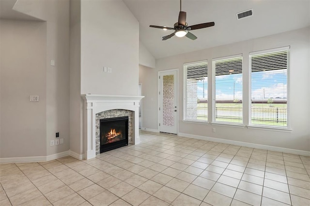 24239 Oakland Mist Ln, Katy, TX 77494 - unfurnished living room featuring ceiling fan, lofted ceiling, light tile patterned flooring, and a stone fireplace
