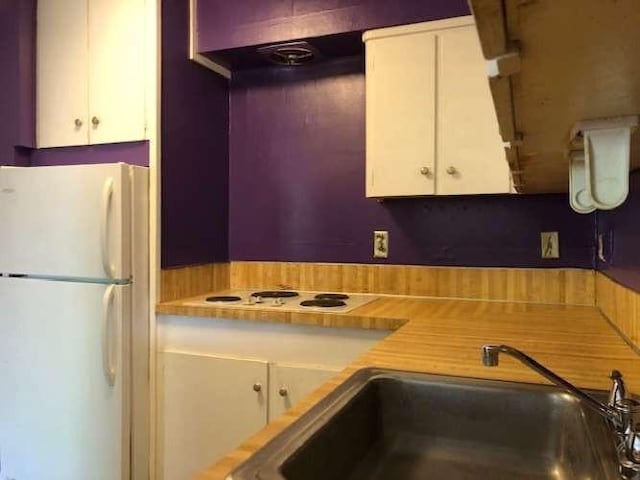 909 Silber Rd Unit 4A, Houston, TX 77024 - kitchen featuring white appliances, white cabinetry, and light countertops