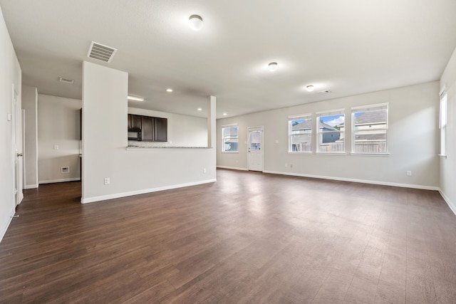 3319 Atascocita Vale Dr, Humble, TX 77396 - unfurnished living room with dark wood-type flooring and recessed lighting