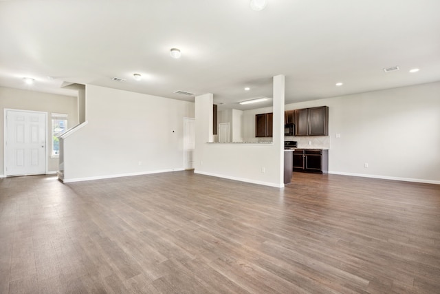 3319 Atascocita Vale Dr, Humble, TX 77396 - unfurnished living room with wood finished floors and recessed lighting