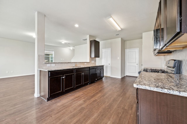 3319 Atascocita Vale Dr, Humble, TX 77396 - kitchen with gas range oven, dark wood-style flooring, backsplash, dark brown cabinets, and dishwasher