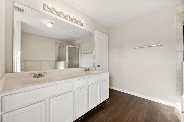 3319 Atascocita Vale Dr, Humble, TX 77396 - full bath featuring a shower with shower door, double vanity, and wood finished floors