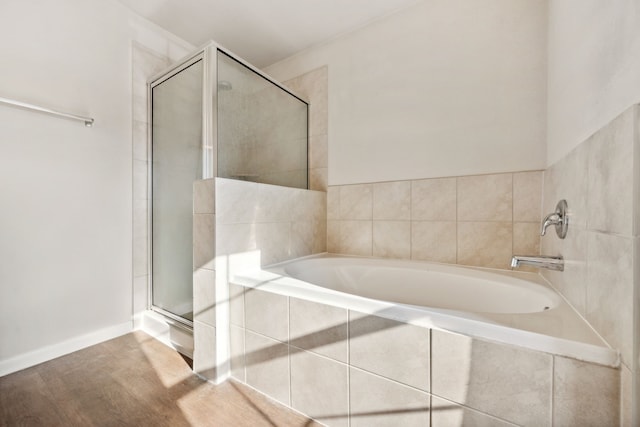 3319 Atascocita Vale Dr, Humble, TX 77396 - bathroom featuring a stall shower, a bath, and wood finished floors