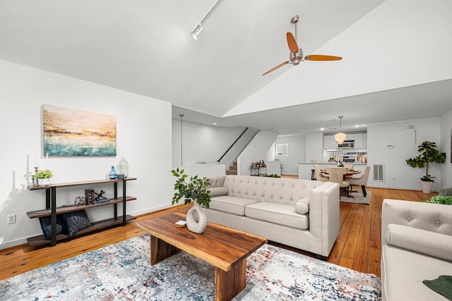 2712 La Branch St, Houston, TX 77004 - living area with stairs, light wood-style floors, ceiling fan, and high vaulted ceiling