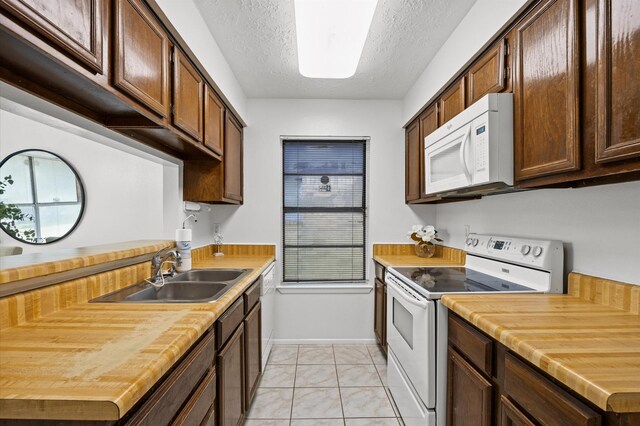 1370 Stevenage Ln, Channelview, TX 77530 - kitchen featuring white appliances, a textured ceiling, wood counters, and light marble finish floors