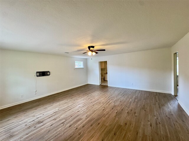 4310 Gallagher Dr, Houston, TX 77045 - unfurnished room with dark wood finished floors, ceiling fan, and a textured ceiling