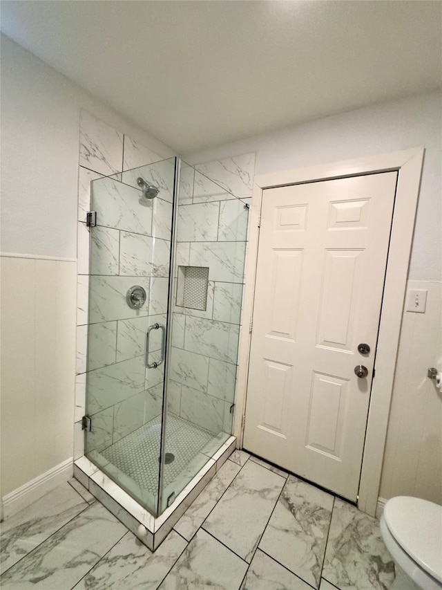 4310 Gallagher Dr, Houston, TX 77045 - bathroom featuring marble finish floors, a marble finish shower, and a wainscoted wall