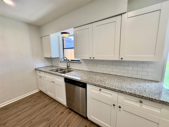 4310 Gallagher Dr, Houston, TX 77045 - kitchen with stainless steel dishwasher, dark wood-style flooring, white cabinetry, tasteful backsplash, and light stone countertops